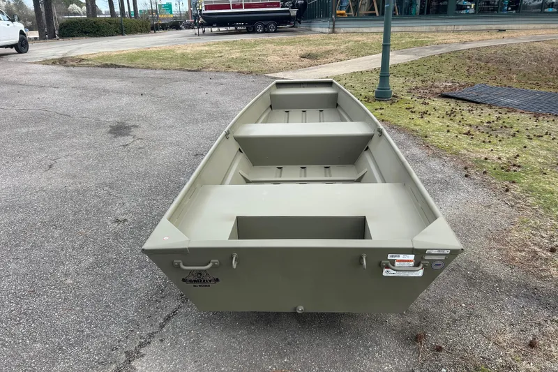 Slide: The Image of 2026 Tracker Grizzly 14 Jon boat on pavement, showcasing its sturdy design. - 4