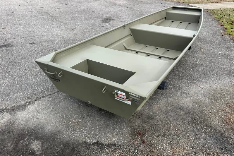 Slide: The Image of 2026 Tracker Grizzly 14 Jon boat on pavement, showcasing its sturdy design. - 5