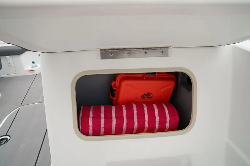 Slide: The Image of Open storage compartment in 2026 Tahoe T21 boat interior. - 23