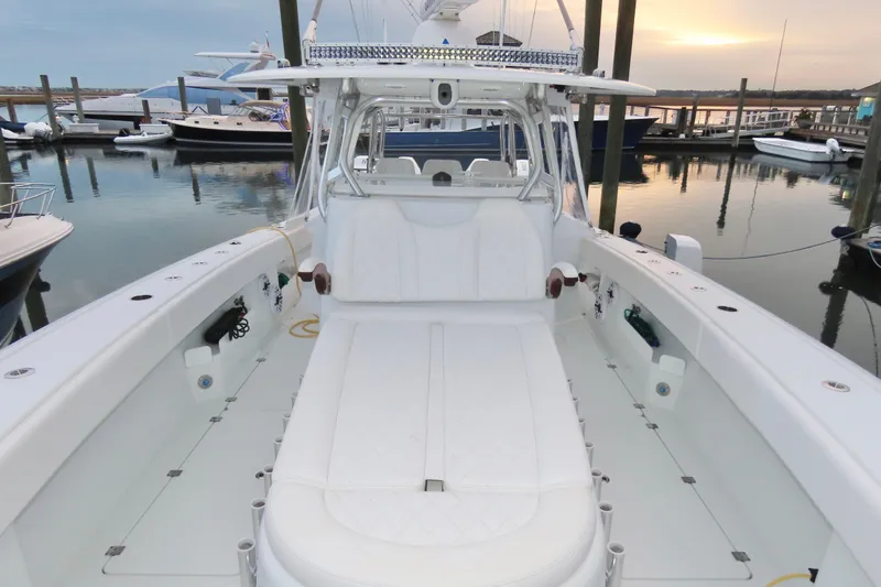 Slide: The Image of 2024 Freeman 38 boat interior at marina during sunset, showcasing spacious seating and sleek design. - 11