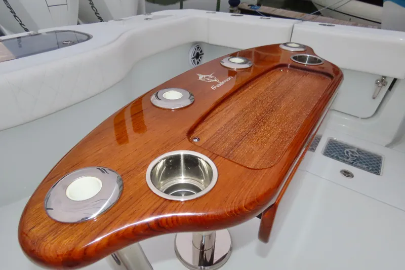 Slide: The Image of Luxurious 2024 Freeman 38 boat with polished wooden table and cup holders. - 12