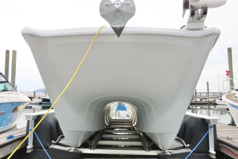 Slide: The Image of 2024 Freeman 38 boat hull on trailer at marina, viewed from front. - 2