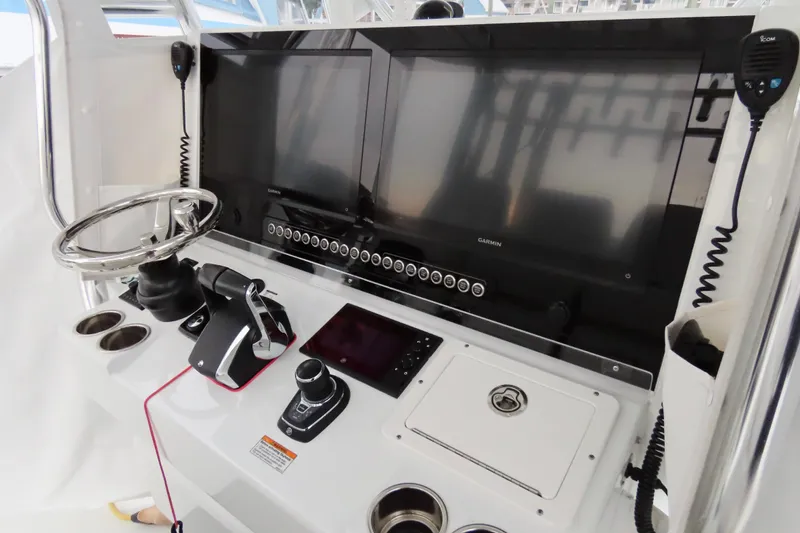 Slide: The Image of 2024 Freeman 38 boat dashboard with dual Garmin screens and modern controls. - 7