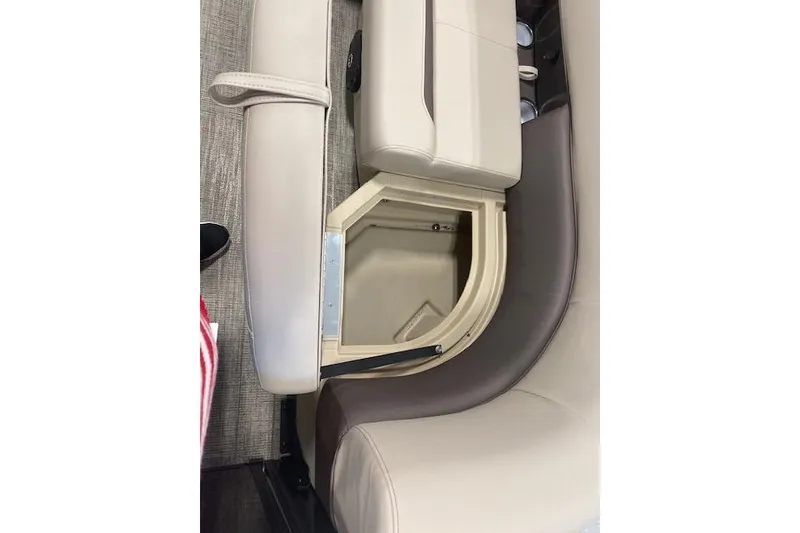 Slide: The Image of 2026 Bentley Pontoons Legacy 223 Navigator seat storage compartment, beige and brown upholstery. - 14