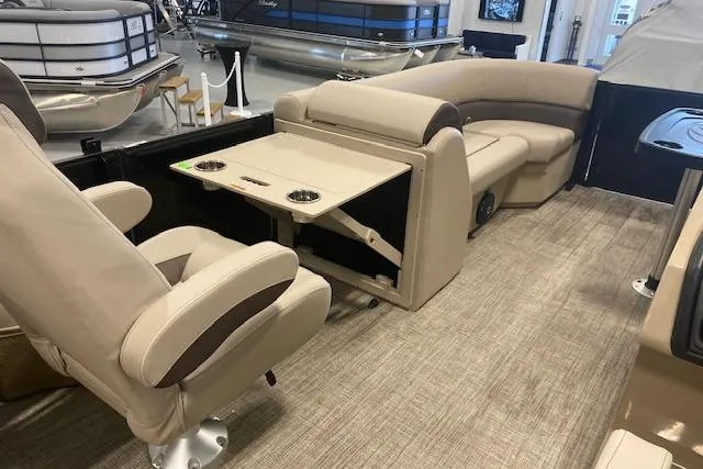 Slide: The Image of 2026 Bentley Pontoons Legacy 223 Navigator interior with beige seating and foldable table. - 18