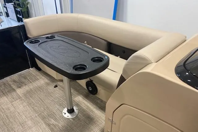 Slide: The Image of 2026 Bentley Pontoons Legacy 223 Navigator interior with beige seating and black table. - 21