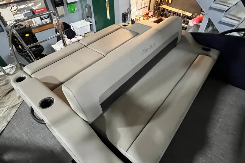 Slide: The Image of 2021 Barletta Cabrio 22UC boat interior with beige seating and cup holders. - 13