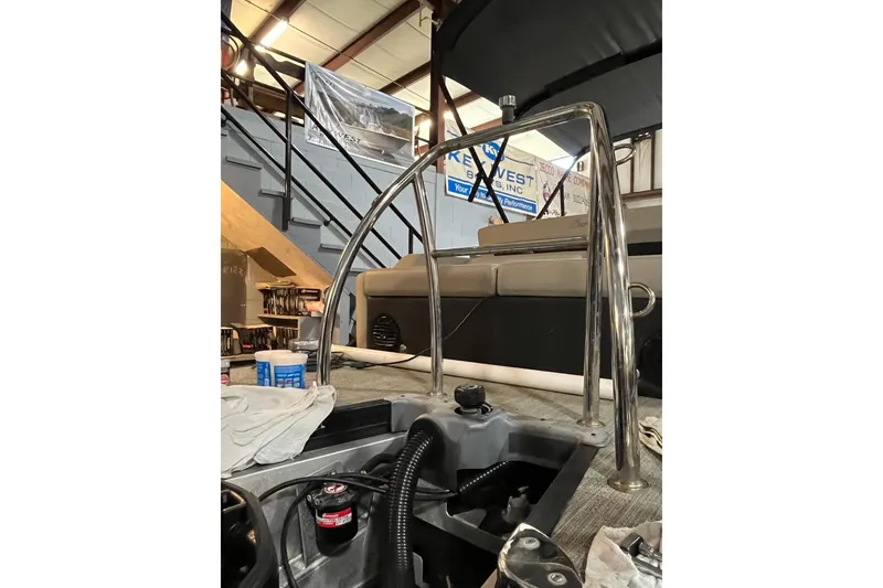 Slide: The Image of 2021 Barletta Cabrio 22UC boat interior with stainless steel railing in a workshop. - 16