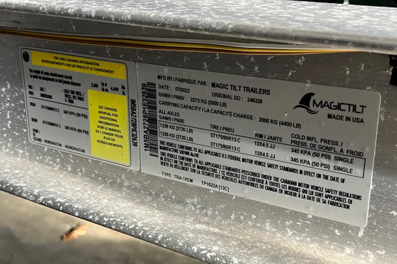 Slide: The Image of Label on Magic Tilt trailer detailing tire and loading information, manufactured in 2022. - 21