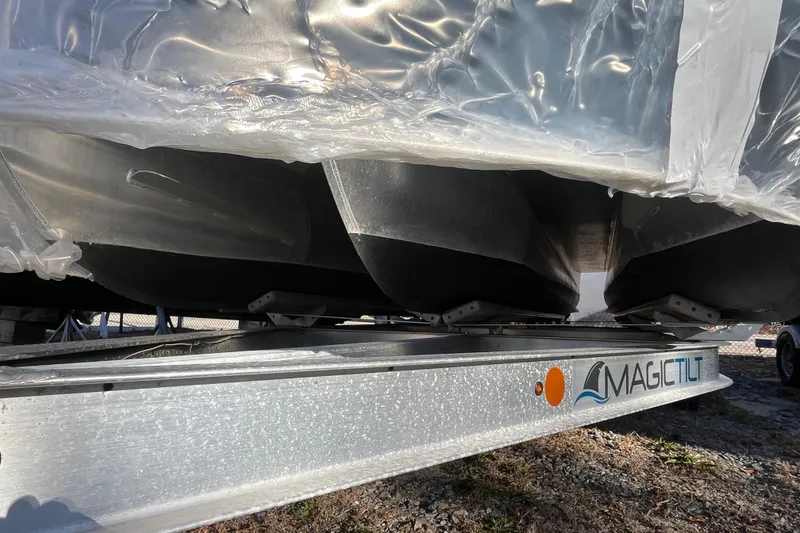 Slide: The Image of 2021 Barletta Cabrio 22UC pontoon boat on Magic Tilt trailer, partially covered. - 4