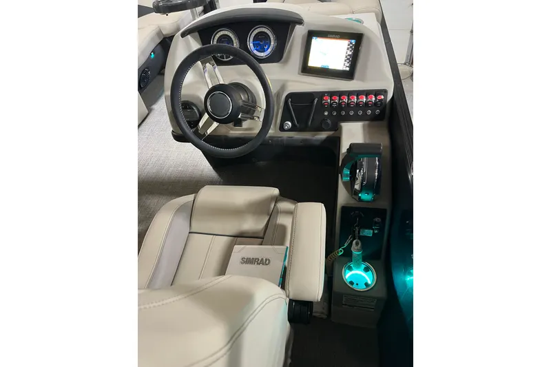 Slide: The Image of 2021 Barletta Cabrio 22UC boat dashboard with steering wheel, controls, and Simrad display. - 8