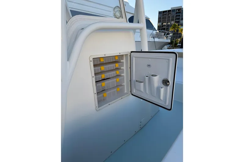 Slide: The Image of 2015 Albury Brothers 27 boat storage compartment with open door and organized trays. - 11