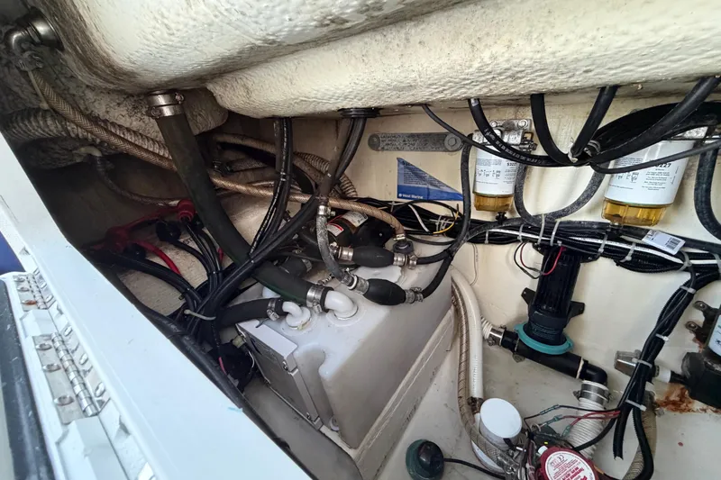 Slide: The Image of Engine compartment of a 2015 Albury Brothers 27 boat, showing hoses and filters. - 12
