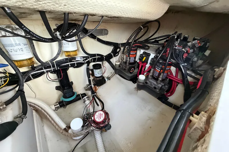 Slide: The Image of Engine compartment of a 2015 Albury Brothers 27 boat, showcasing wiring and components. - 14