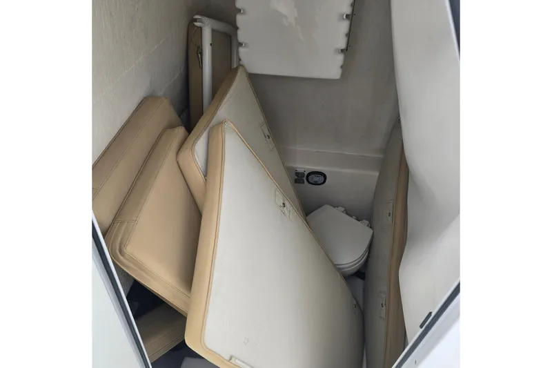 Slide: The Image of Interior of 2015 Albury Brothers 27 boat with stored cushions and compact toilet. - 19