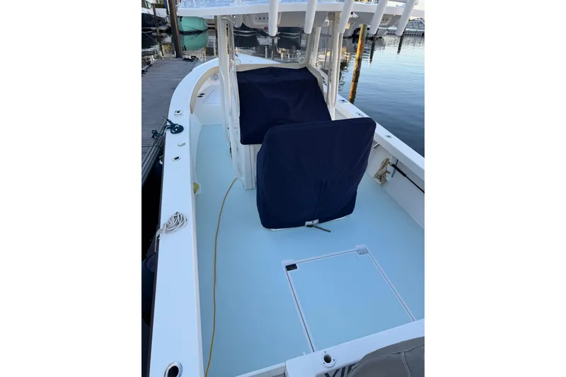 Slide: The Image of 2015 Albury Brothers 27 boat interior with covered seats at a dock. - 4