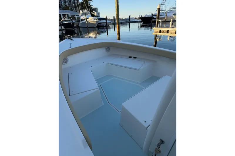 Slide: The Image of 2015 Albury Brothers 27 boat interior at marina, showcasing seating and storage. - 5
