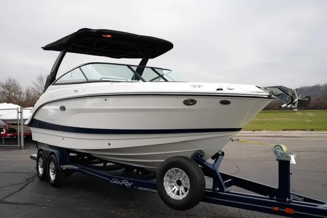 Slide: The Image of 2026 Sea Ray SLX 260 boat on trailer, sleek design, white hull, black canopy. - 10