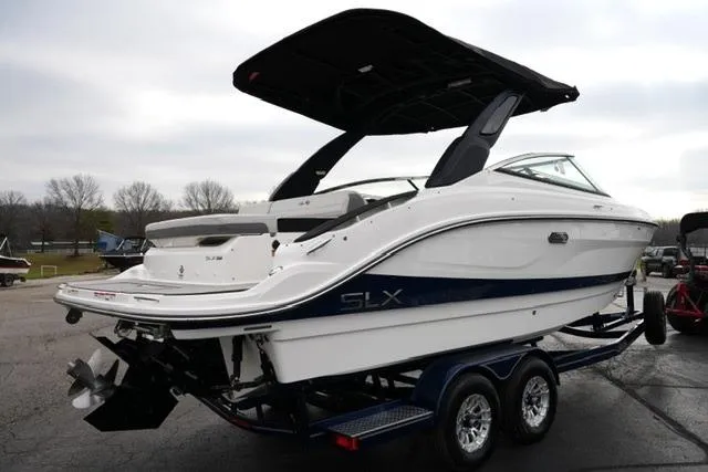 Slide: The Image of 2026 Sea Ray SLX 260 boat on trailer, sleek design, white and blue exterior. - 12