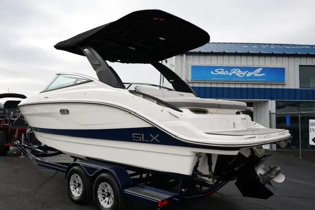 Slide: The Image of 2026 Sea Ray SLX 260 boat on trailer, displayed outside dealership. - 13
