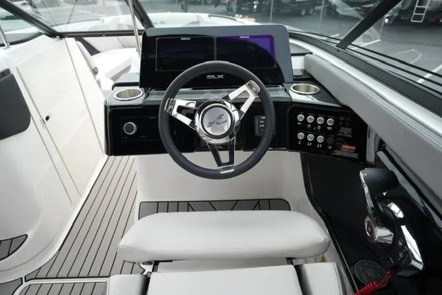 Slide: The Image of 2026 Sea Ray SLX 260 boat cockpit with modern steering and control panel. - 23