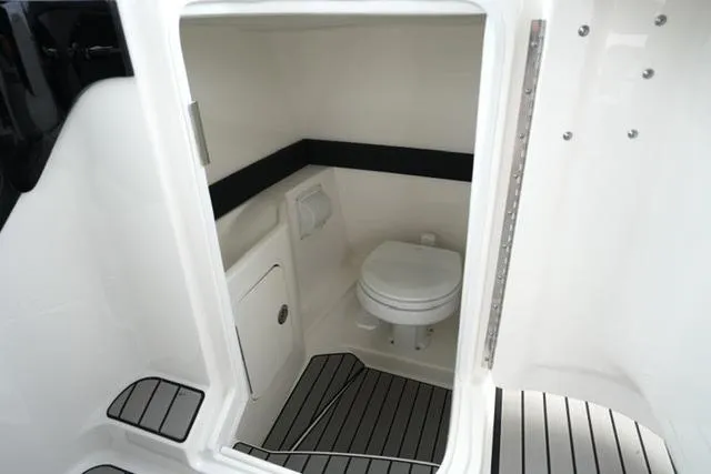 Slide: The Image of 2026 Sea Ray SLX 260 boat interior with modern bathroom and sleek design. - 26