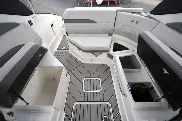 Slide: The Image of 2026 Sea Ray SLX 260 boat interior with open storage compartments and sleek seating design. - 28