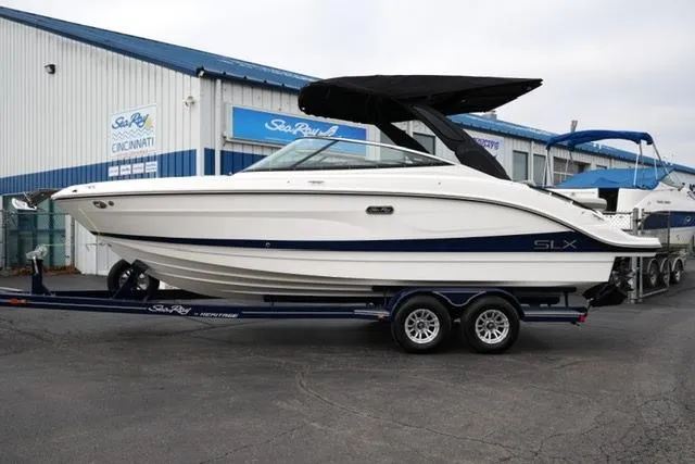 The Image of 2026 Sea Ray SLX 260 boat on trailer outside dealership. - 8