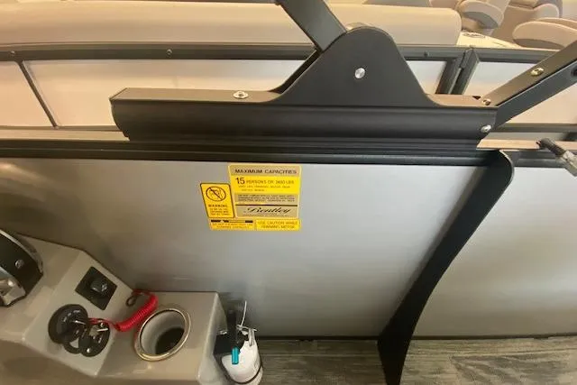 Slide: The Image of 2026 Bentley Pontoons Legacy 223 Swingback interior with capacity label and control panel. - 13