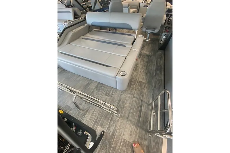 Slide: The Image of 2026 Bentley Pontoons Legacy 223 Swingback interior with gray seating and wood-style flooring. - 7