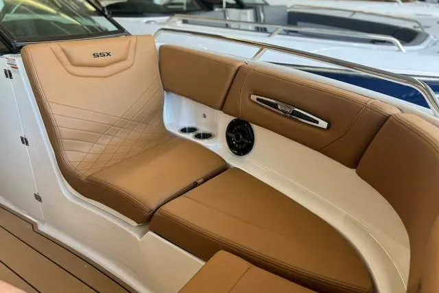 Slide: The Image of 2025 Chaparral 247 SSX boat interior with tan leather seating and sleek design. - 11
