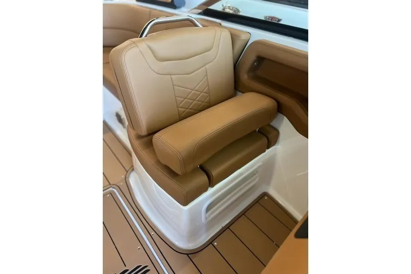 Slide: The Image of Luxurious tan seating in 2025 Chaparral 247 SSX boat interior. - 16
