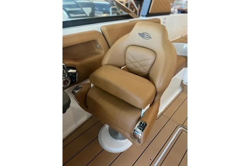 Slide: The Image of 2025 Chaparral 247 SSX boat seat with tan leather and elegant stitching. - 18