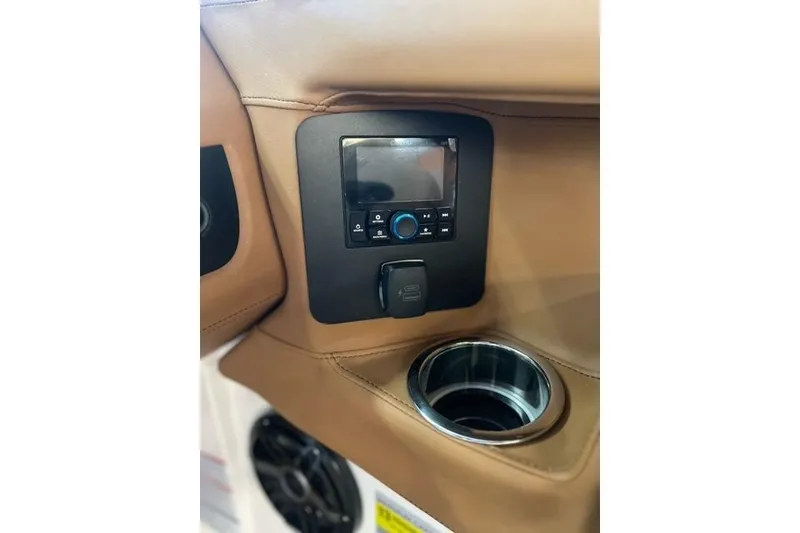 Slide: The Image of 2025 Chaparral 247 SSX boat interior with control panel and cup holder. - 22