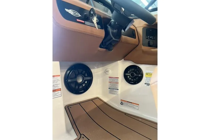 Slide: The Image of Interior view of 2025 Chaparral 247 SSX boat, featuring steering wheel and speaker system. - 24
