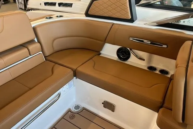 Slide: The Image of 2025 Chaparral 247 SSX boat interior with tan leather seating and modern design. - 27