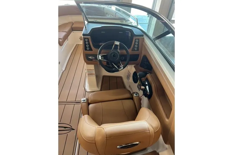 Slide: The Image of 2025 Chaparral 247 SSX boat interior with tan leather seating and modern dashboard. - 35