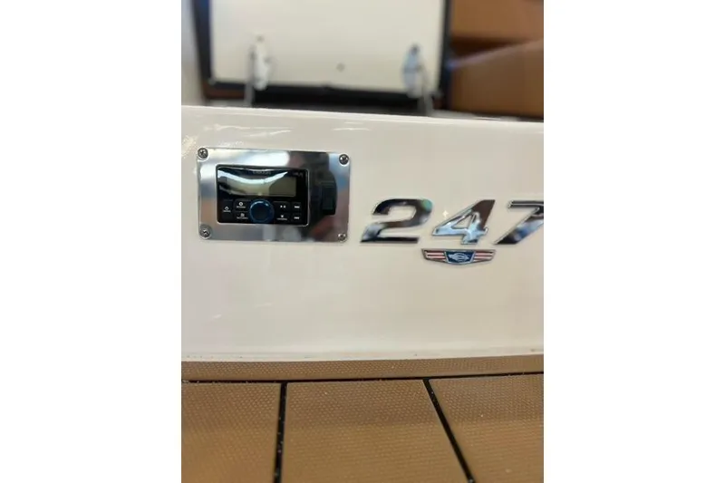 Slide: The Image of 2025 Chaparral 247 SSX boat dashboard with control panel and model emblem. - 38