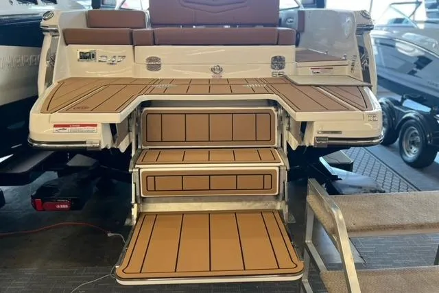 Slide: The Image of 2025 Chaparral 247 SSX boat with teak-style swim platform and steps in showroom. - 41