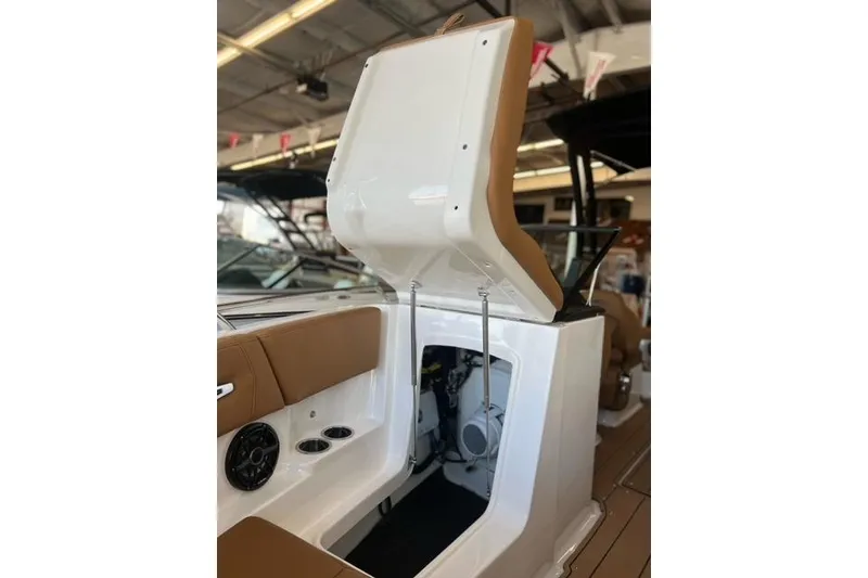 Slide: The Image of 2025 Chaparral 247 SSX boat interior with open storage compartment and seating. - 9