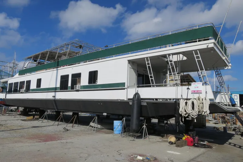 The Image of 2001 Sumerset houseboat on land, for sale, with blue sky background. - 0