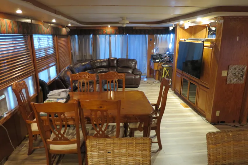 Slide: The Image of Luxurious 2001 Sumerset houseboat interior with leather seating, dining area, and modern kitchen. - 17