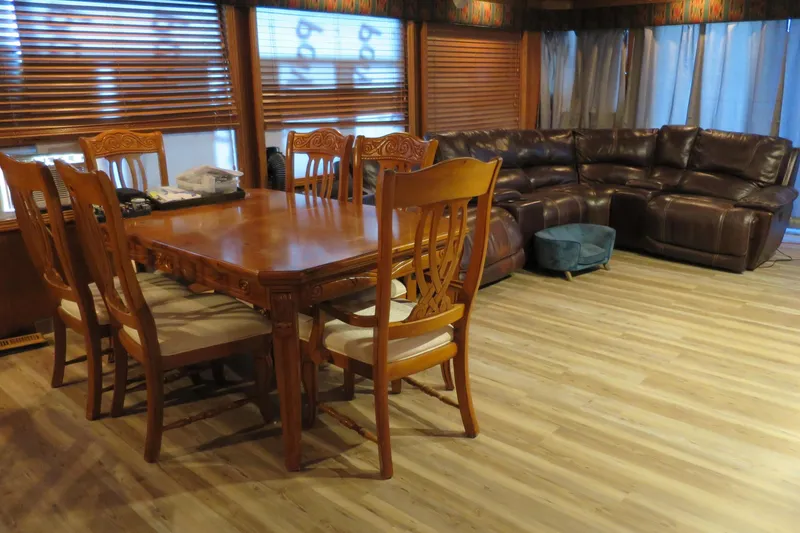 Slide: The Image of Interior of a 2001 Sumerset houseboat with dining area and cozy seating. - 18