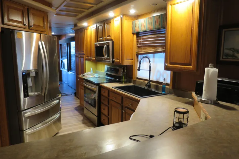 Slide: The Image of Interior of a 2001 Sumerset houseboat with wooden furniture and leather sofa. - 19