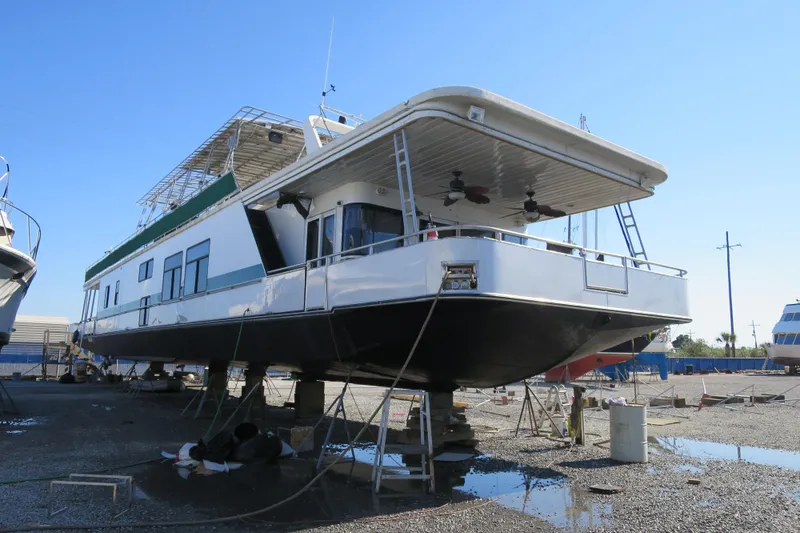 Slide: The Image of 2001 Sumerset houseboat on dry dock under clear blue sky. - 2