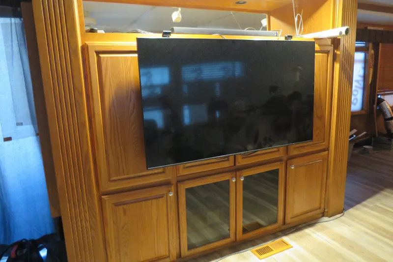 Slide: The Image of 2001 Sumerset houseboat kitchen with wooden cabinets and bar stools. - 21