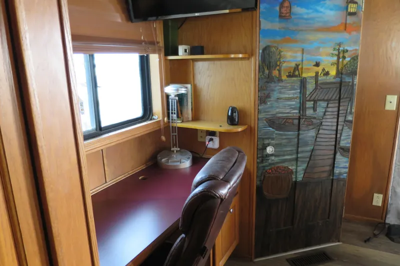 Slide: The Image of Wooden entertainment center with mounted TV inside 2001 Sumerset houseboat interior. - 22