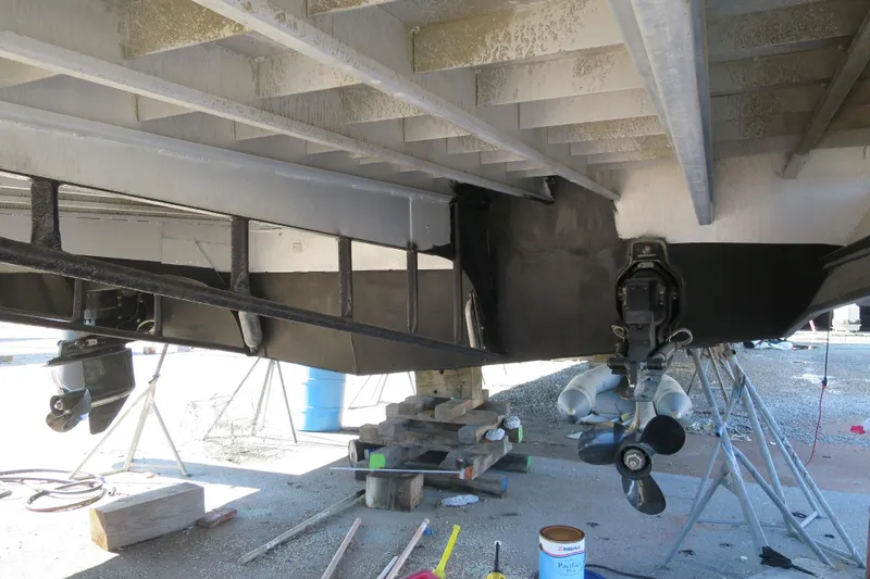 Slide: The Image of 2001 Sumerset houseboat on dry dock with visible ceiling fans and maintenance equipment. - 5