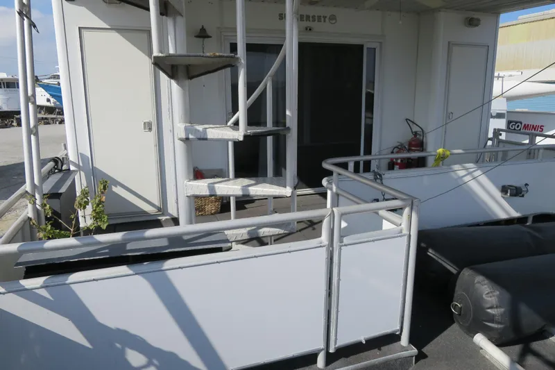 Slide: The Image of 2001 Sumerset houseboat deck with outdoor furniture and canopy in a marina setting. - 8