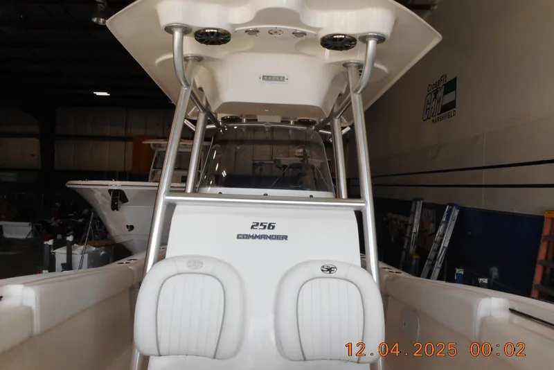 Slide: The Image of 2014 Sea Fox 256 Commander boat interior with seating and console in a garage setting. - 12